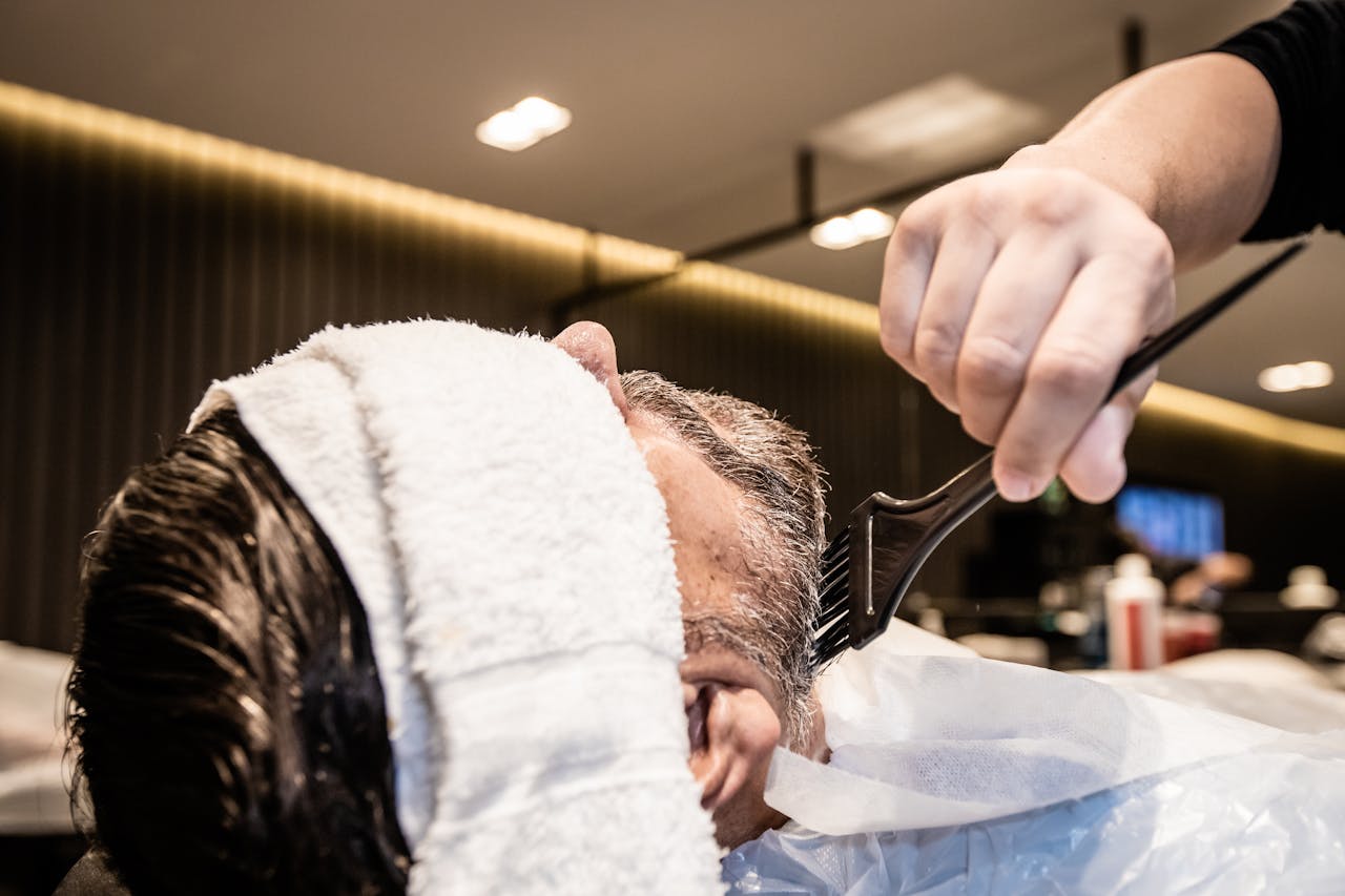 Professional grooming session at a barbershop in João Pessoa with a focus on beard styling.
