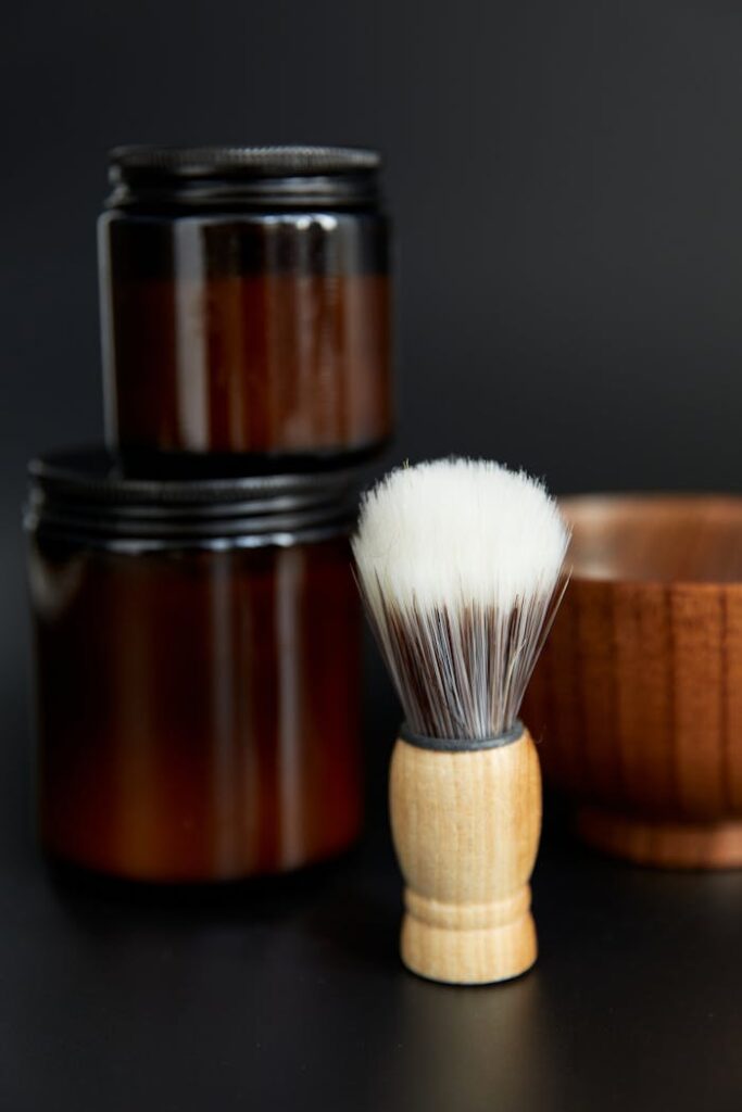 pexels-photo-8789612 Classic shaving brush and jars with black background for grooming and hygiene.
